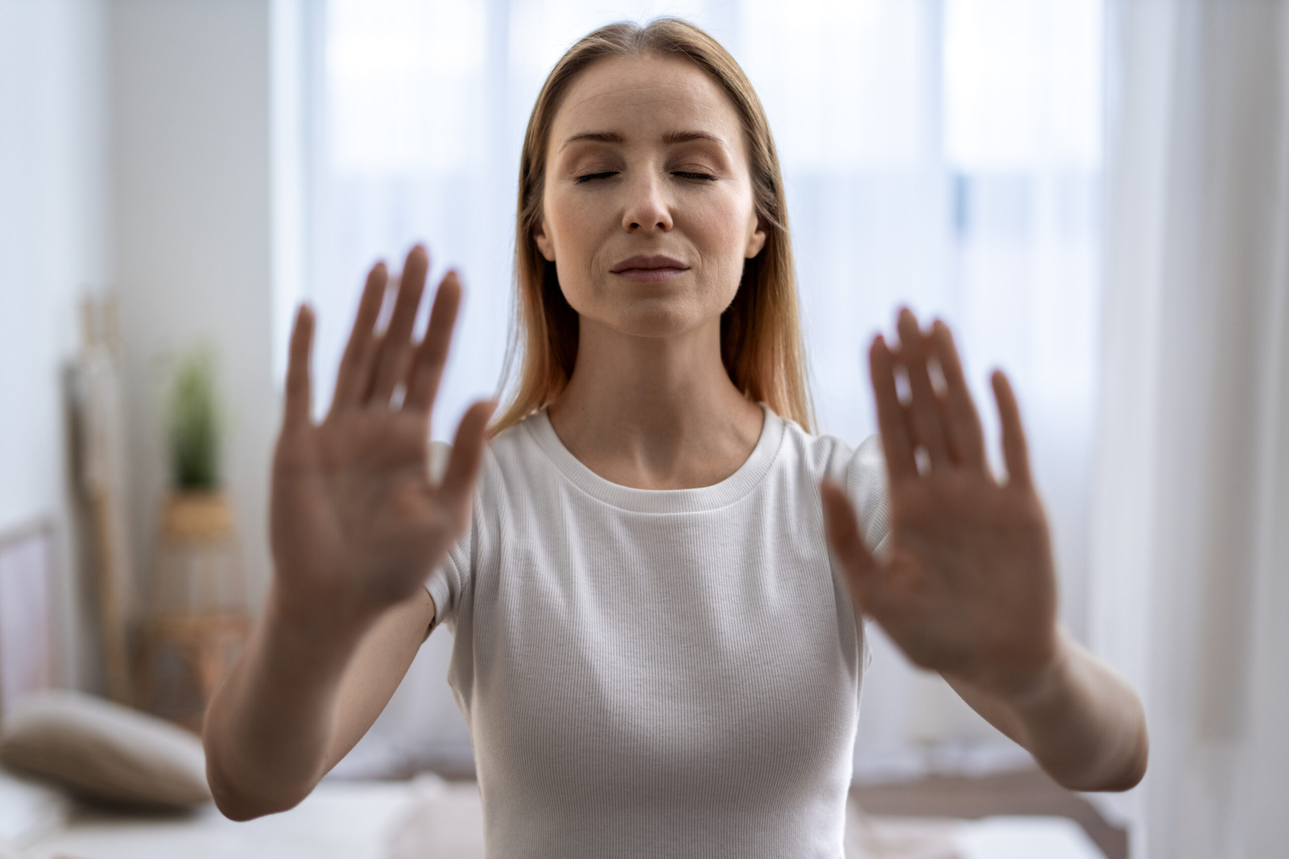 person-practicing-tai-chi-indoors